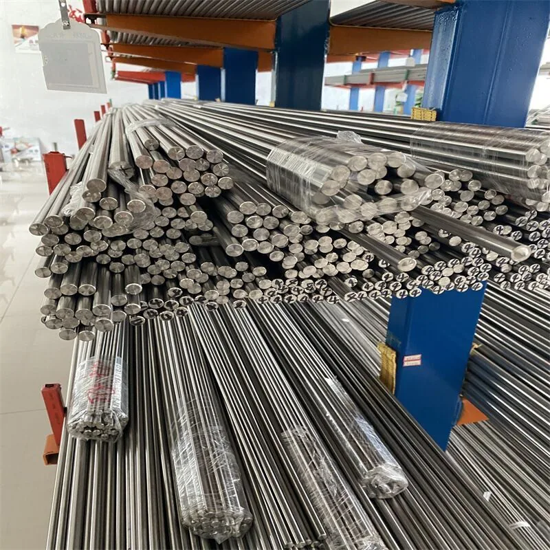 Long titanium bars stored horizontally in a workshop
