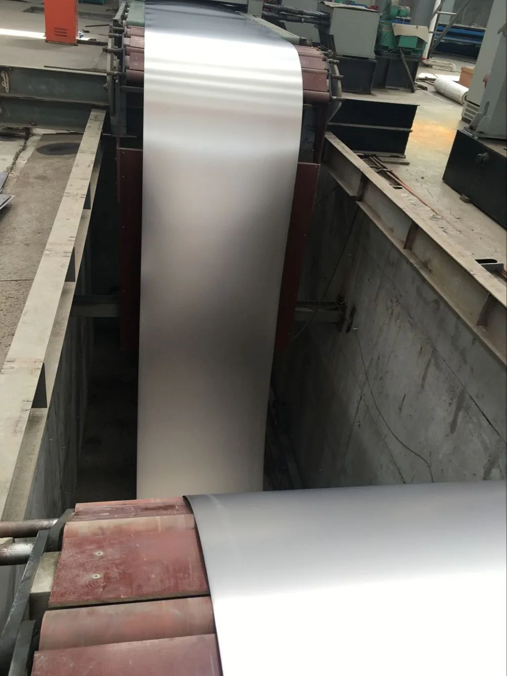 Titanium coil secured with a steel strap