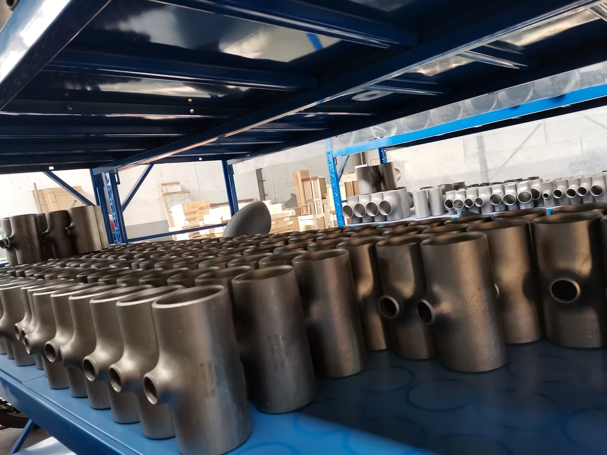 Group of machined titanium parts on a workshop floor