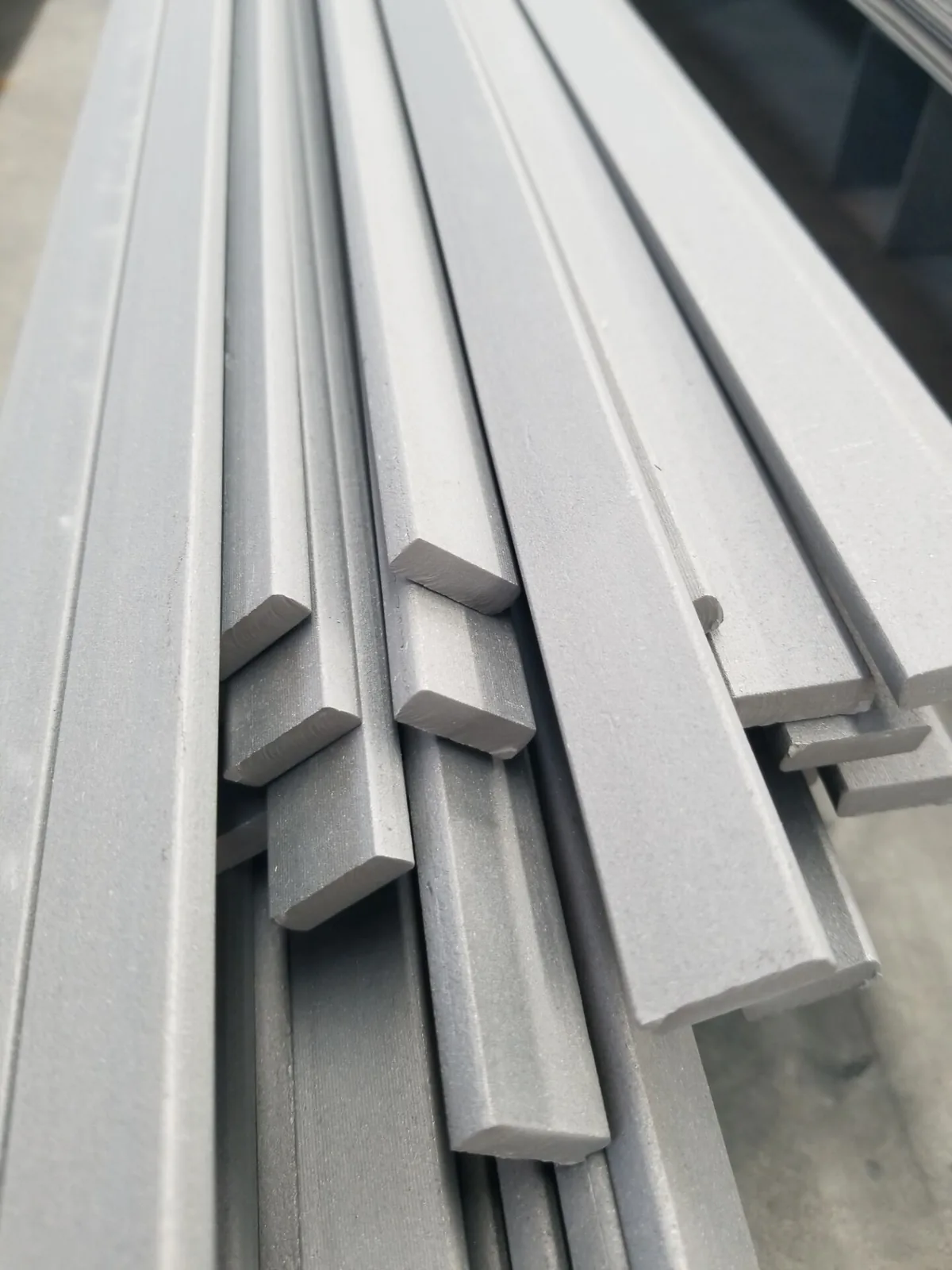 Several thin titanium sheets held together showing thickness